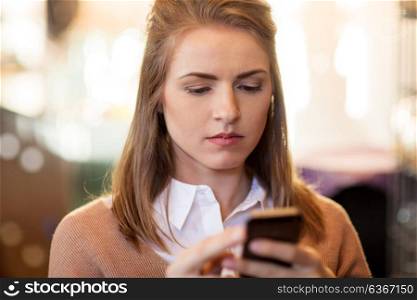 technology, lifestyle and people concept - close up of young woman with smartphone. close up of young woman with smartphone