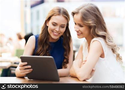 technology, lifestyle, friendship and people concept - happy young women or teenage girls with tablet pc at cafe outdoors