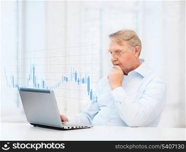 technology, money, oldness and business concept - old man in eyeglasses with laptop computer and forex chart at home
