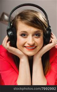 Technology, music and happiness concept - smiling girl teenage in headphones listening music