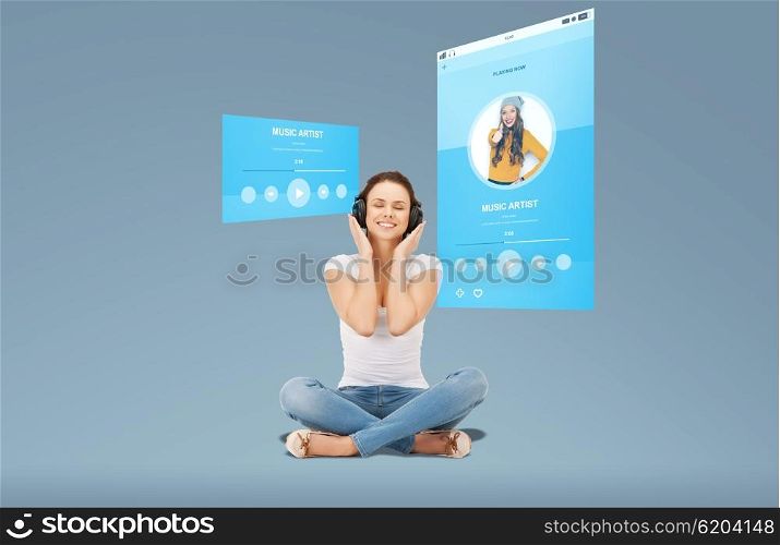 technology, music, multimedia and happiness concept - smiling young woman or teen girl in headphones over media player screen and blue background