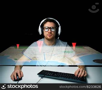 technology, navigation, location and people concept - young man in headset and eyeglasses with pc computer keyboard and gps navigator virtual map