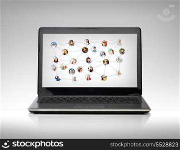 technology, networking and communication concept - laptop computer with social network on screen