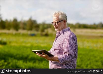 technology, old age and people concept - senior man with tablet pc computer at county