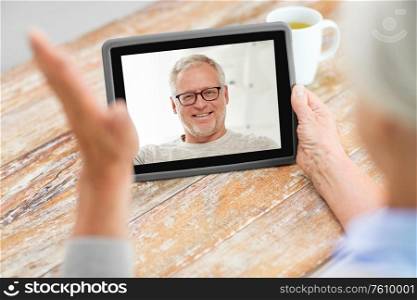 technology, online communication and quarantine concept - senior woman having video call with happy senior man on tablet computer at home. senior woman having video call with senior man