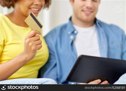 technology, online shopping and people concept - happy couple couple with tablet pc computer and credit card. couple with tablet pc and credit card