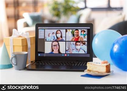 technology, pandemic and online communication concept - laptop computer with happy people on screen having video call or virtual birthday party at home. laptop with video call or online birthday party