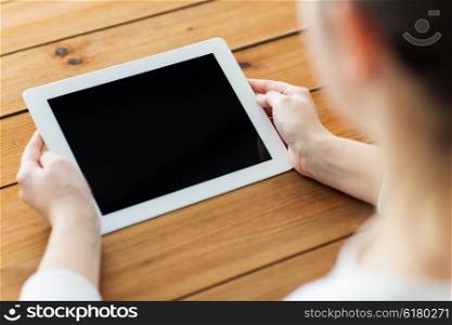 technology, people and advertisement concept - close up of woman with blank tablet pc computer screen on wooden table