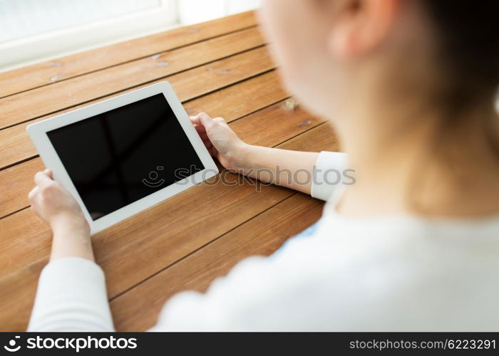 technology, people and advertisement concept - close up of woman with blank tablet pc computer screen on wooden table