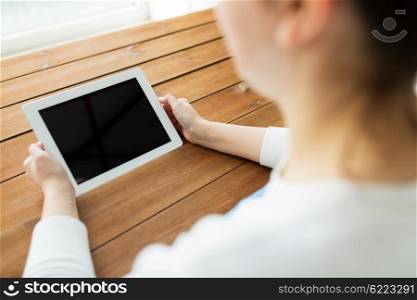 technology, people and advertisement concept - close up of woman with blank tablet pc computer screen on wooden table