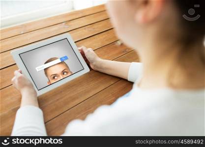 technology, people and advertisement concept - close up of woman with internet browser search bar on tablet pc computer screen on wooden table