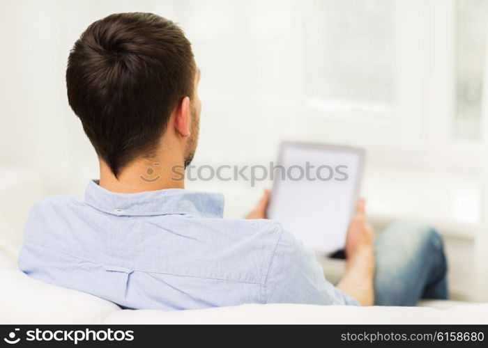 technology, people and lifestyle, distance learning concept - close up of man working with tablet pc computer at home