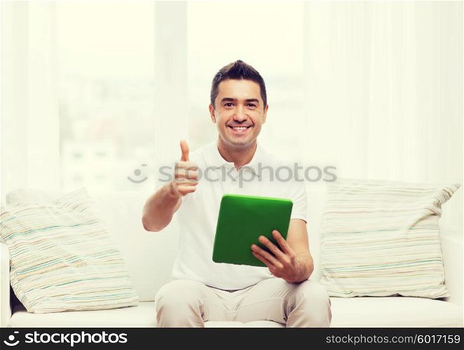 technology, people and lifestyle, distance learning concept - happy man working with tablet pc computer at home