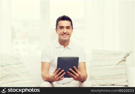 technology, people and lifestyle, distance learning concept - happy man working with tablet pc computer at home