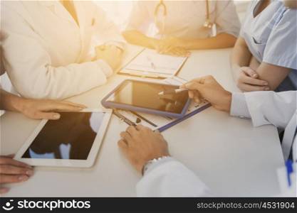 technology, people and medicine concept - group of doctors with tablet pc computers and clipboards meeting at hospital
