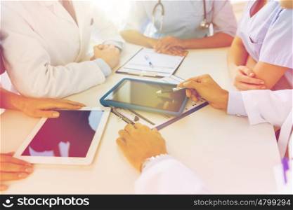 technology, people and medicine concept - group of doctors with tablet pc computers and clipboards meeting at hospital