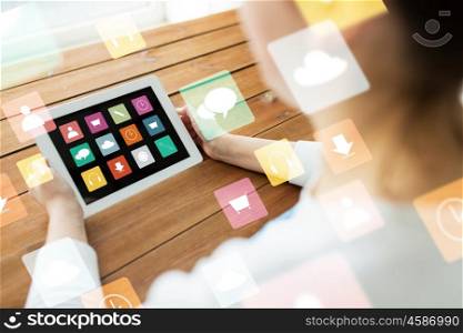 technology, people and multimedia concept - close up of woman with menu icons on tablet pc computer screen on wooden table
