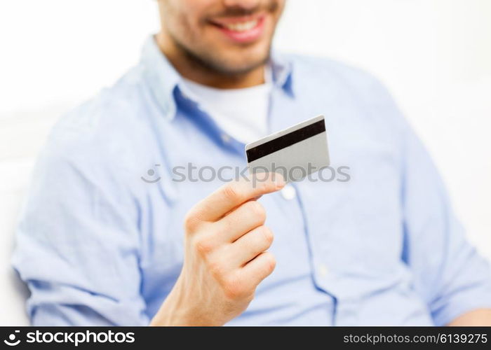 technology, people and online shopping concept - close up of man with credit card