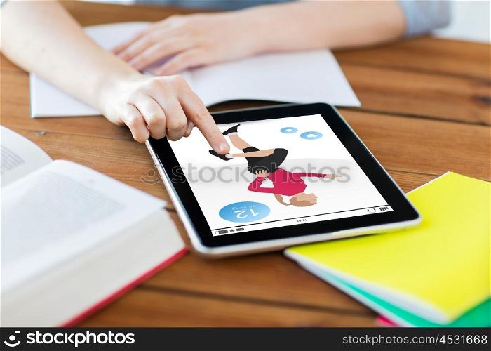 technology, people and sport concept - close up of student woman with fitness application on tablet pc computer and notebook at home