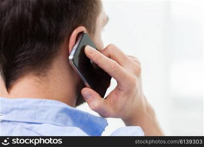 technology, people, lifestyle and communication concept - close up of man calling on smartphone at home