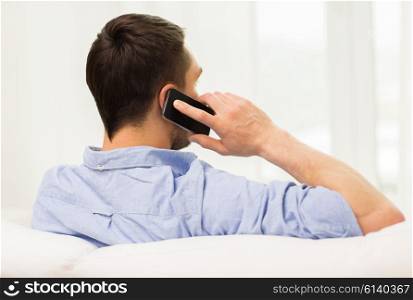 technology, people, lifestyle and communication concept - close up of man calling on smartphone at home