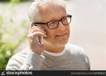 technology, people, lifestyle and communication concept - happy senior man calling on smartphone in city
