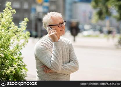 technology, people, lifestyle and communication concept - happy senior man calling on smartphone in city. happy senior man calling on smartphone in city