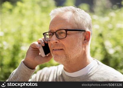 technology, people, lifestyle and communication concept - happy senior man calling on smartphone in city. happy senior man calling on smartphone in city