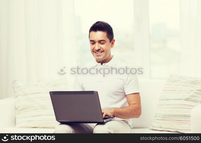 technology, people lifestyle and networking concept - happy man working with laptop computer at home