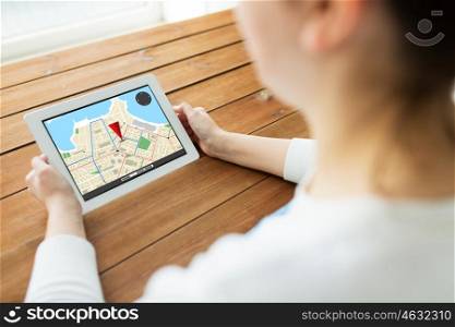 technology, people, navigation and location concept - close up of woman with gps navigator map on tablet pc computer screen on wooden table