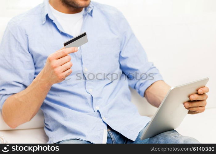 technology, people, online shopping, banking and lifestyle concept - close up of man with tablet pc computer and credit or bank card at home