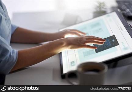 technology, programming and people concept - hands working with data on led light tablet or touch screen at office. hands working with led light tablet at office