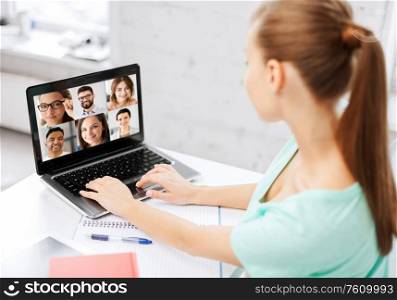 technology, remote job and online education concept - young woman or student girl with laptop computer having video call with colleagues or teachers at home. woman with laptop has video call with colleagues