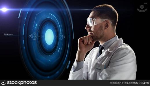 technology, science, and people concept - male doctor or scientist in white coat and safety glasses looking at virtual projection over black background. scientist in goggles looking at virtual projection