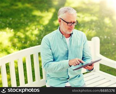 technology, senior people, and lifestyle, distance learning concept - old man with tablet pc computer at summer park. senior man with tablet pc at summer park