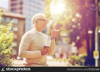 technology, senior people, lifestyle and communication concept - happy old man using voice command recorder or calling on smartphone outdoors. old man using voice command recorder on smartphone