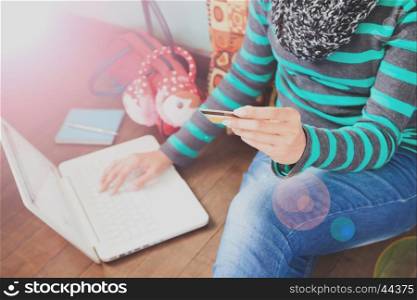 Technology, shopping, banking, home and lifestyle concept - close up of female with laptop computer and credit card at home
