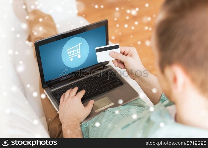 technology, shopping, banking, home and lifestyle concept - close up of man with laptop computer and credit card at home