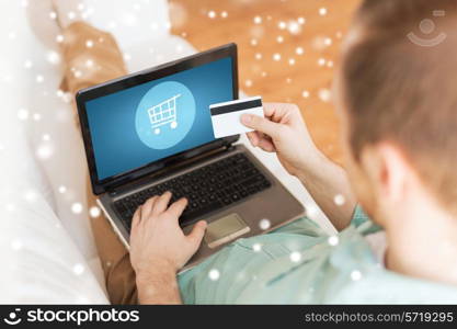 technology, shopping, banking, home and lifestyle concept - close up of man with laptop computer and credit card at home