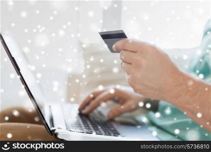 technology, shopping, banking, home and people concept - close up of man with laptop computer and credit card at home