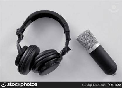 technology, sound recording and audio equipment concept - headphones and microphone on white background. headphones and microphone on white background