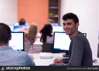 technology students group in computer lab school classroom working on