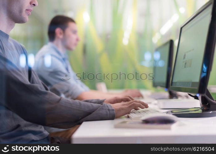 technology students group in computer lab school classroom working on