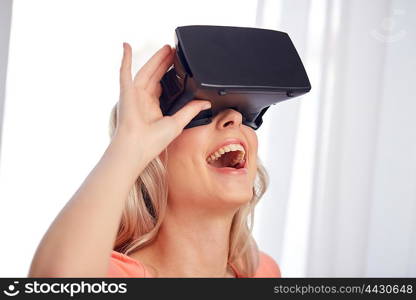 technology, virtual reality, cyberspace, entertainment and people concept - happy amazed young woman with virtual reality headset or 3d glasses at home