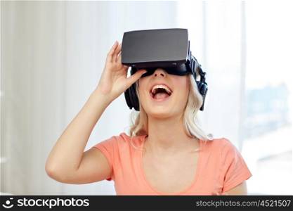 technology, virtual reality, cyberspace, entertainment and people concept - happy amazed young woman in virtual reality headset or 3d glasses and headphones at home