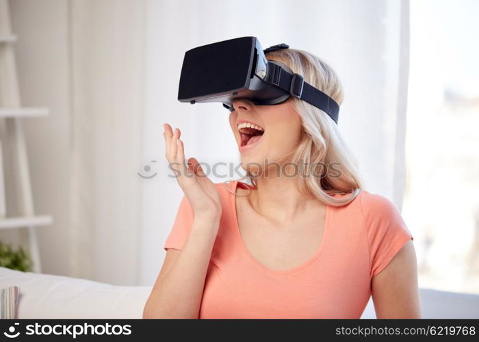 technology, virtual reality, cyberspace, entertainment and people concept - happy amazed young woman with virtual reality headset or 3d glasses at home