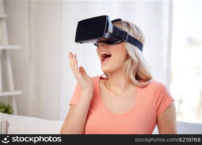 technology, virtual reality, cyberspace, entertainment and people concept - happy amazed young woman with virtual reality headset or 3d glasses at home