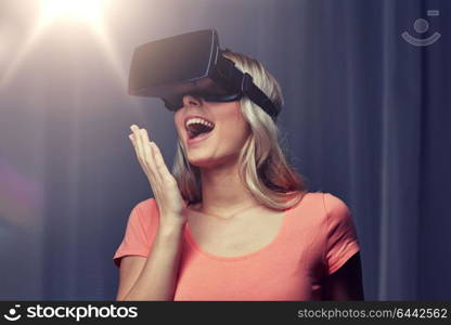 technology, virtual reality, cyberspace, entertainment and people concept - happy amazed young woman with virtual reality headset or 3d glasses at home. woman in virtual reality headset or 3d glasses