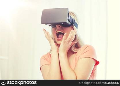 technology, virtual reality, cyberspace, entertainment and people concept - happy amazed young woman with virtual reality headset or 3d glasses at home. woman in virtual reality headset or 3d glasses