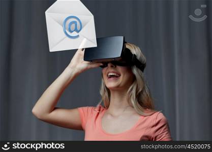 technology, virtual reality, cyberspace, entertainment and people concept - happy young woman with virtual reality headset or 3d glasses at home looking at email icon projection